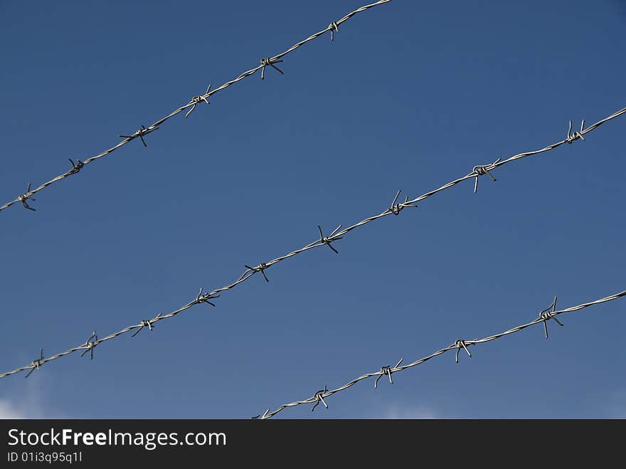 Barbed wire and the blue sky