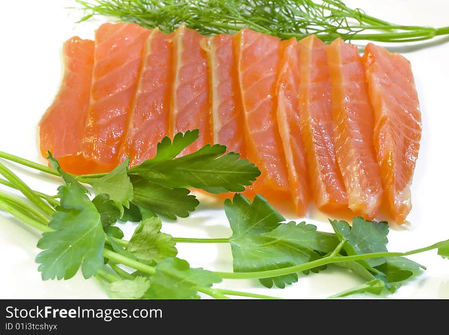 Salmon with fennel and parsley, a photo close up on a white background. Salmon with fennel and parsley, a photo close up on a white background.