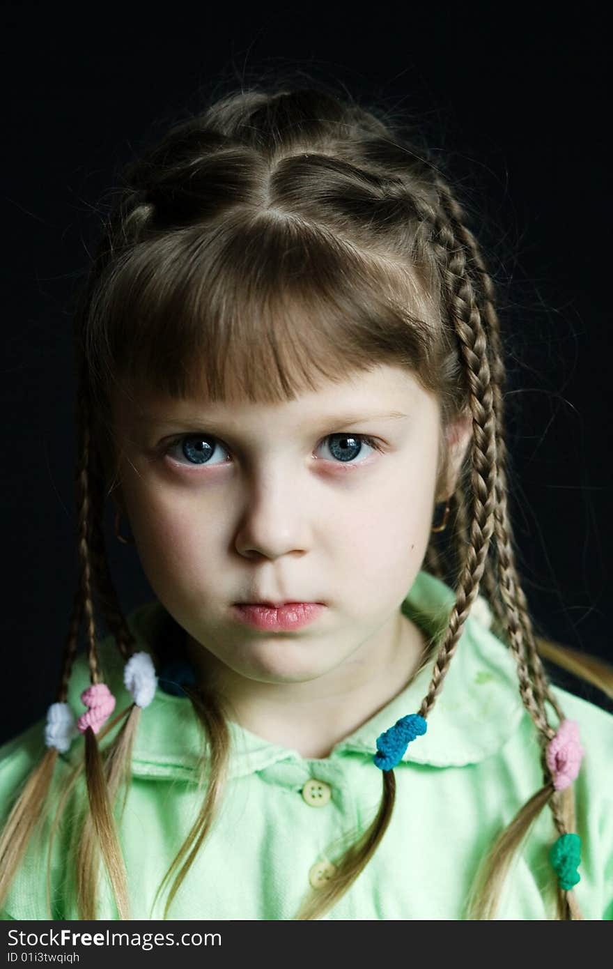 Stock photo: an image of a sad little girl with pigtails. Stock photo: an image of a sad little girl with pigtails