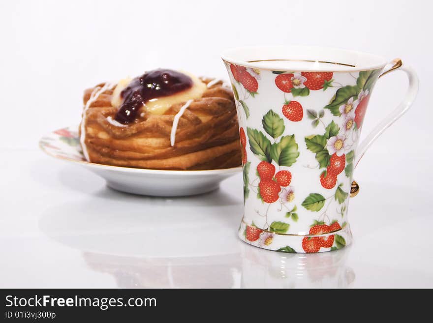 Cup and cake photo on a white background