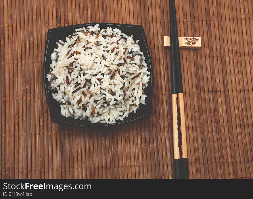 Rice in cup and chinese sticks