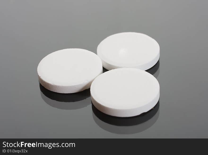 Macro of pills on glass background