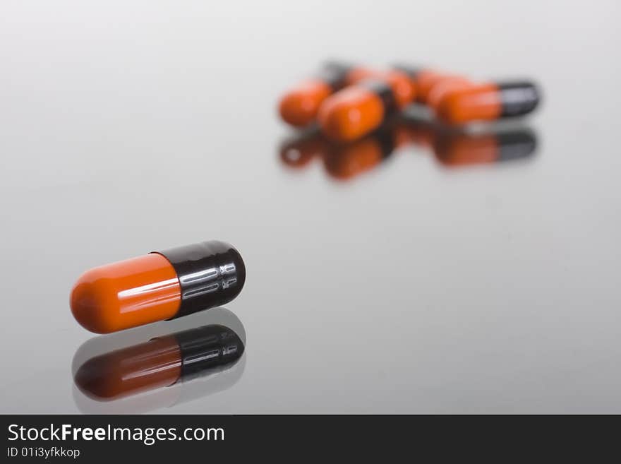 Macro of pill on glass background