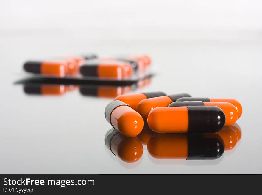 Macro of pills on glass background