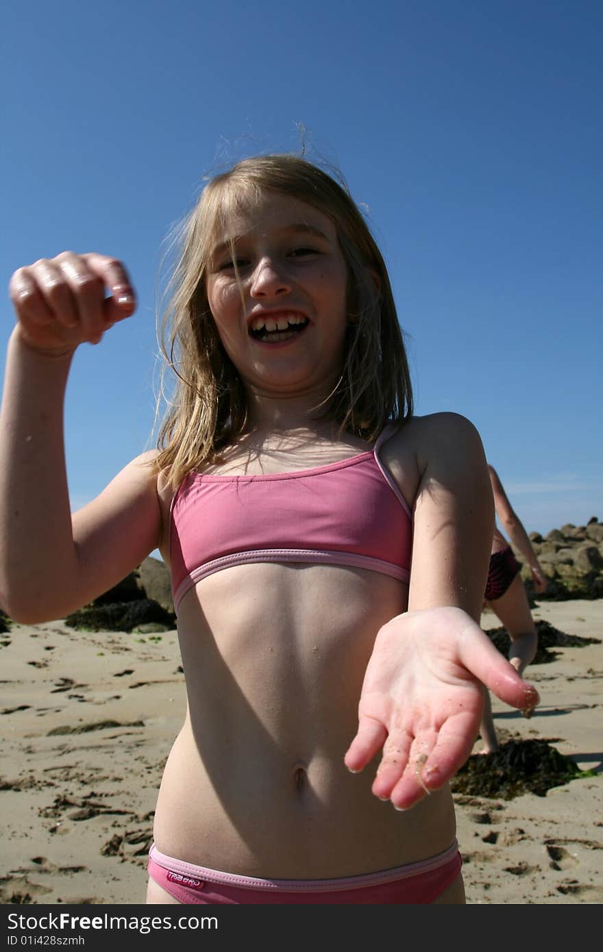 Girl showing her findings on the beach