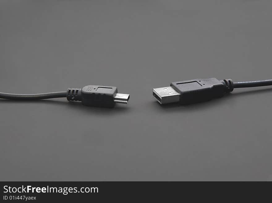 USB and miniUSB cords isolated on black. USB and miniUSB cords isolated on black