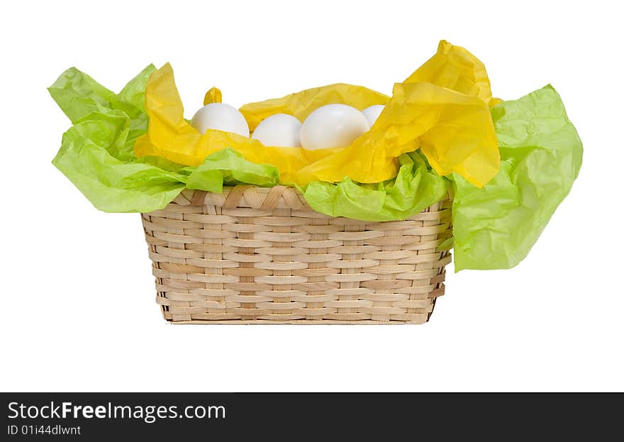 Basket with eggs and tissue paper yellow and green. Basket with eggs and tissue paper yellow and green.