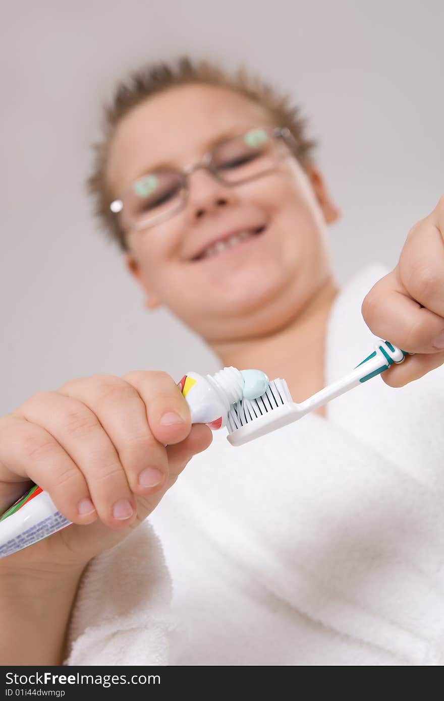 Funny young boy cleaning teeth