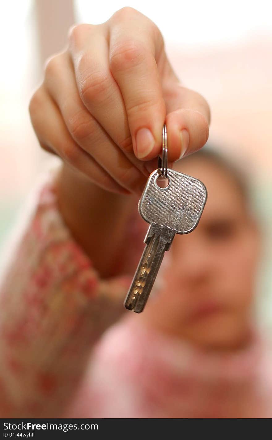 Hand holds a key (key in focus)