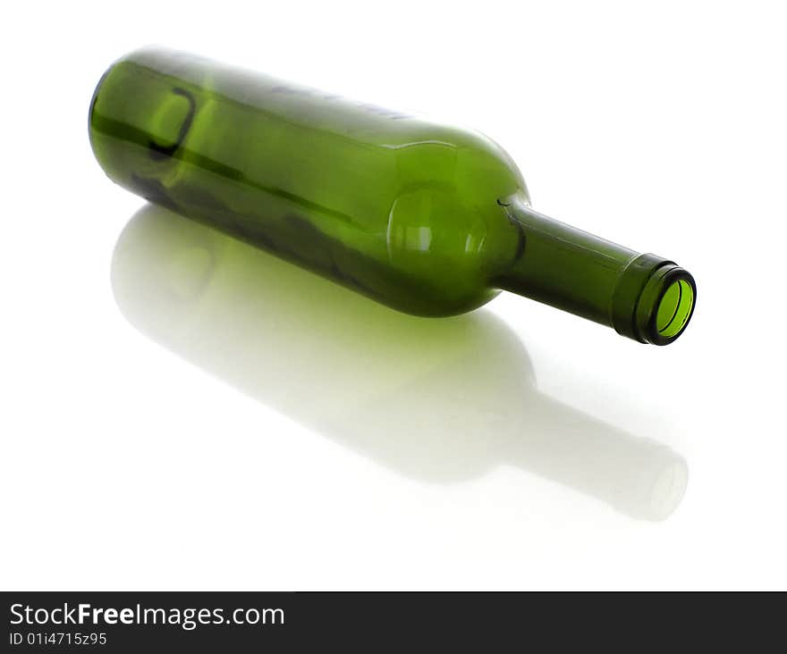 A green glass on a white background with a reflection and a shadow. A green glass on a white background with a reflection and a shadow.