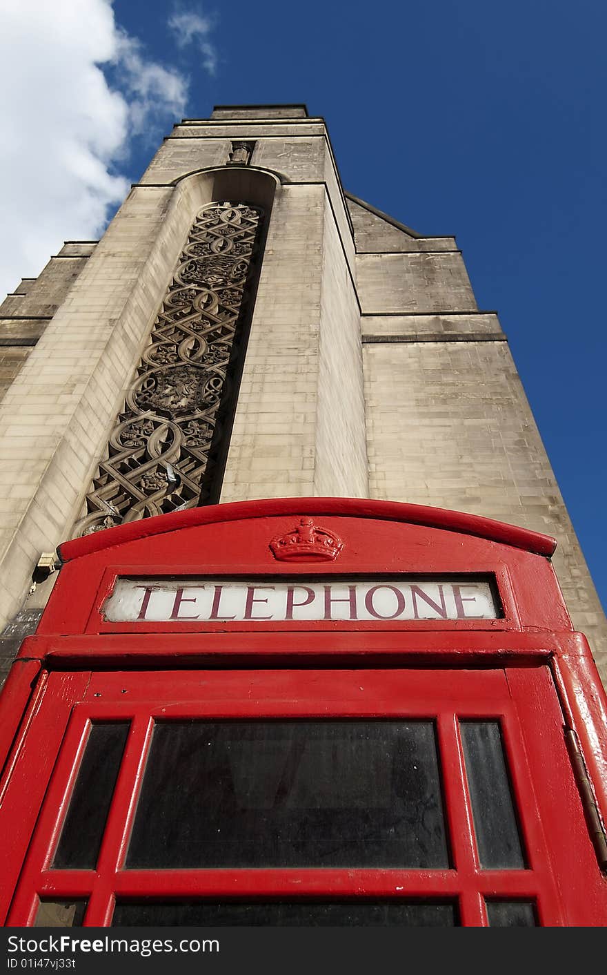 Shot of traditional British telephone box with a view of part of the Manchester Town Hall building in the background. Shot of traditional British telephone box with a view of part of the Manchester Town Hall building in the background.