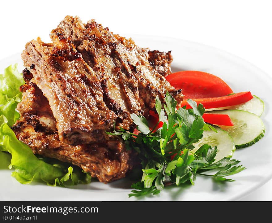 Beef (or Pork) Grilled with Greens and Vegetables on a Plate. Isolated on White Background