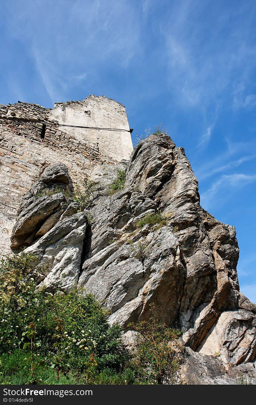 Ruins of an ancient castle on the gray furrowed rock. Ruins of an ancient castle on the gray furrowed rock