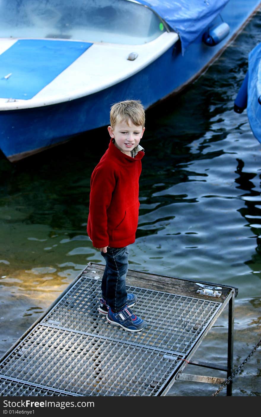 Young by on a pier by the river. Young by on a pier by the river