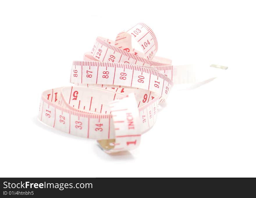 Rolled red and white measuring tape on white background