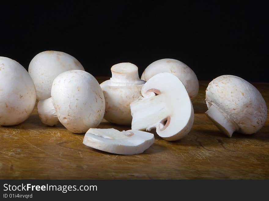 Mushroom on the table and black background. Mushroom on the table and black background