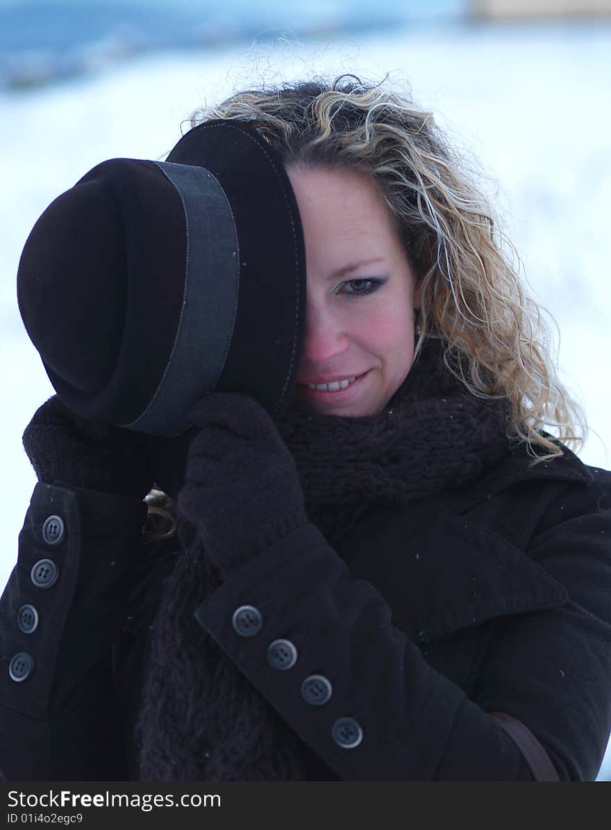 Girl with brown hat hiding one eye