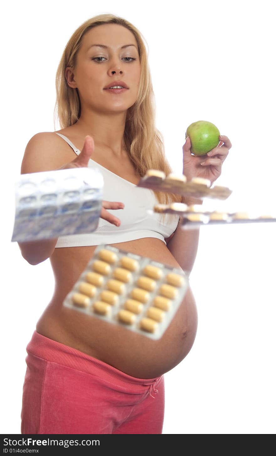 Pregnant woman with apple and tablets isolated on a white. Pregnant woman with apple and tablets isolated on a white