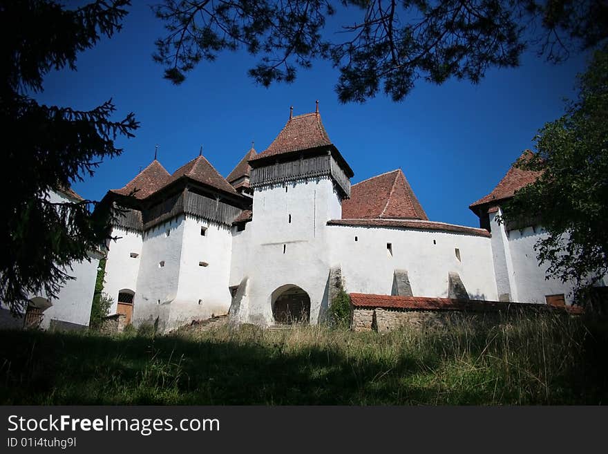 Ancient fortified church apon blue ski. Ancient fortified church apon blue ski