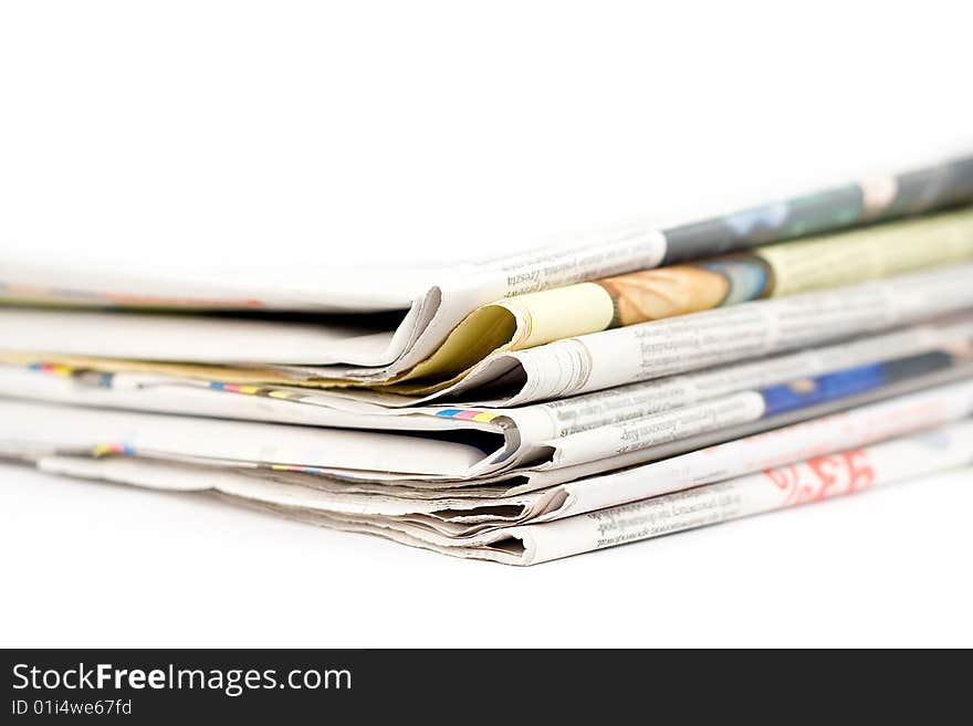 Stack of newspapers in color isolated on white background