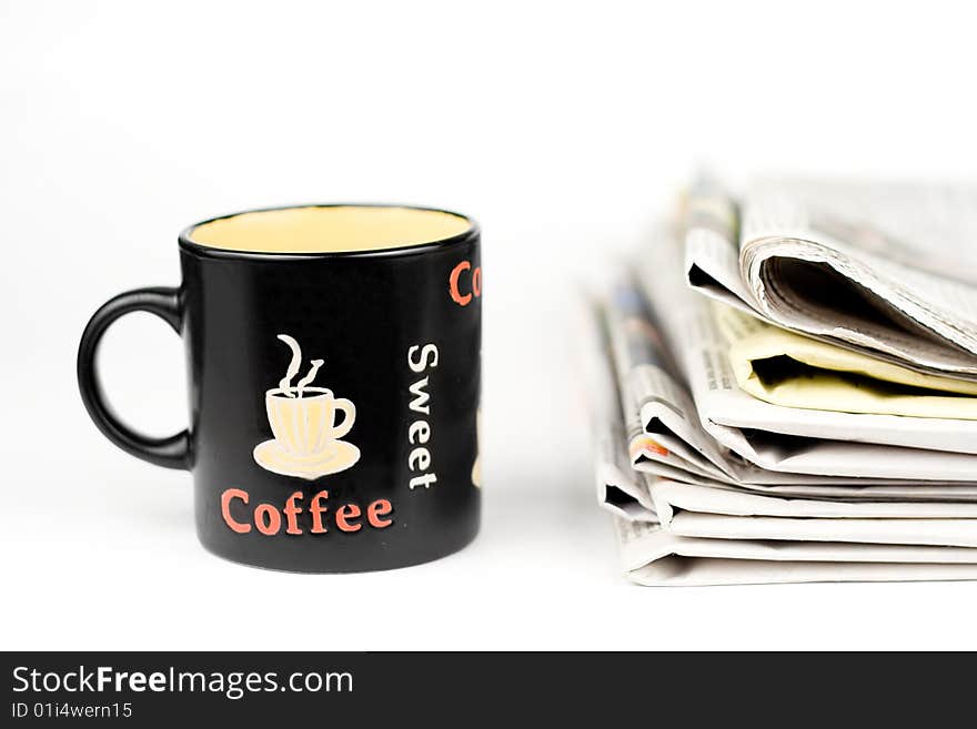 Coffee cup and stack of newspapers isolated on white background