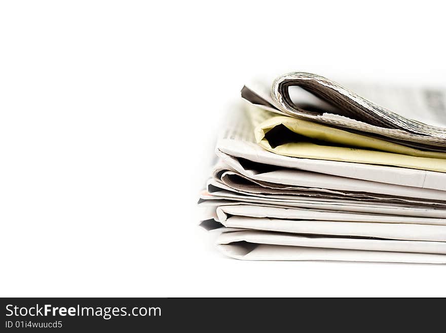 Stack of newspapers in color isolated on white background