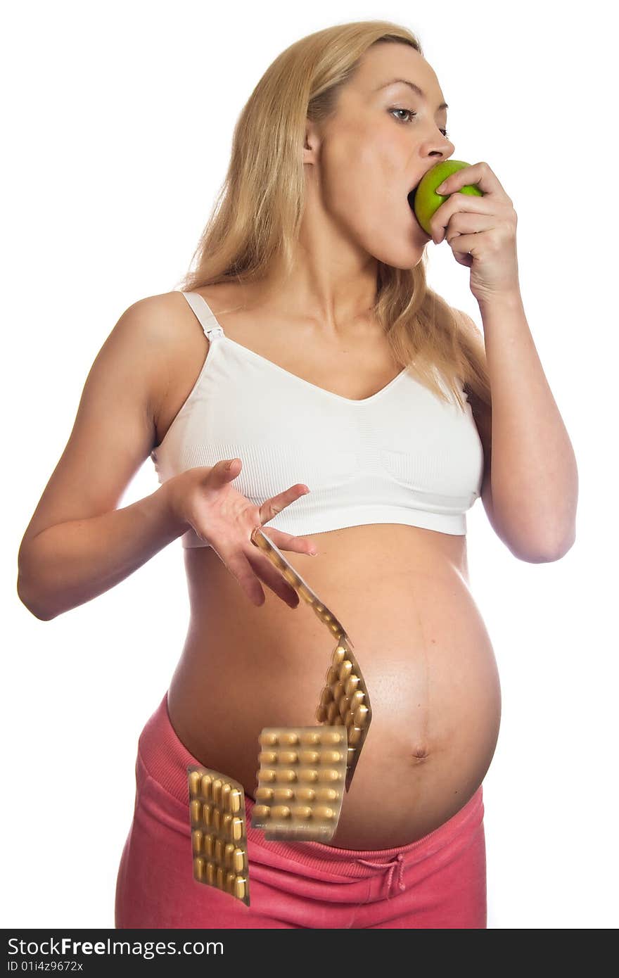 Pregnant woman with apple and tablets isolated on a white. Pregnant woman with apple and tablets isolated on a white