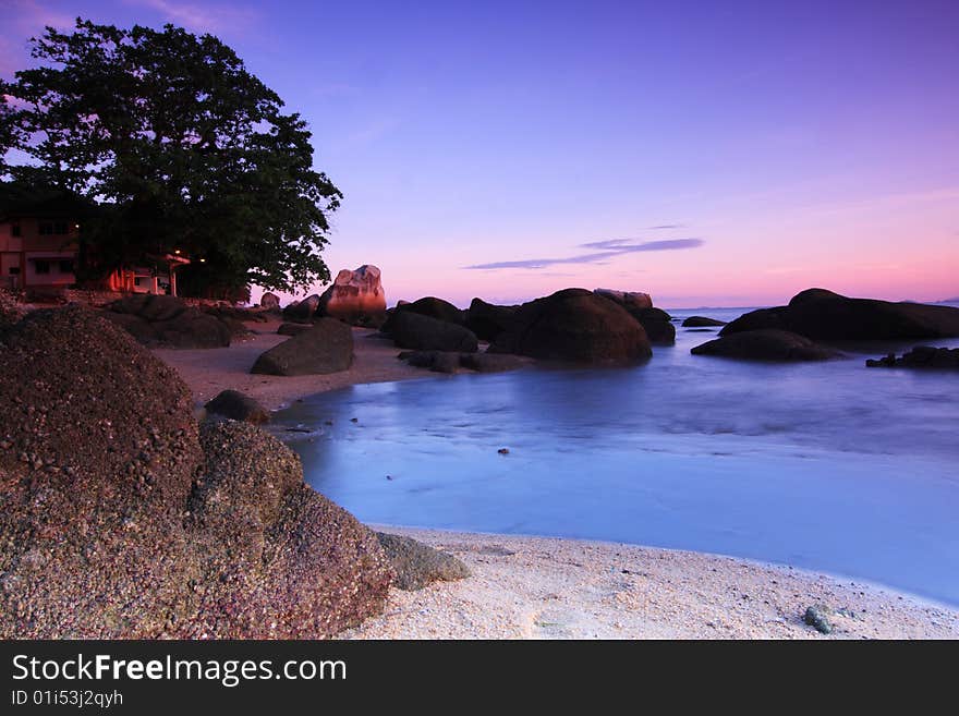 Beautiful sunrise with blue water and skies with a thin orange layer of the sun early in the morning. Beautiful sunrise with blue water and skies with a thin orange layer of the sun early in the morning.