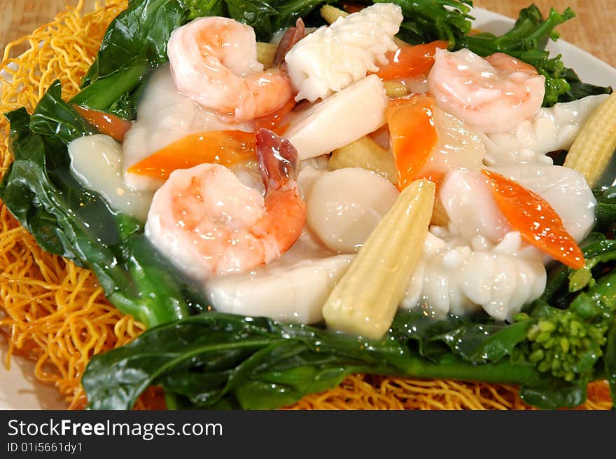 Glazed seafood over crispy noodles