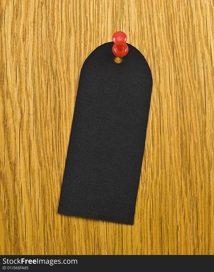 Black blank tag on wooden background