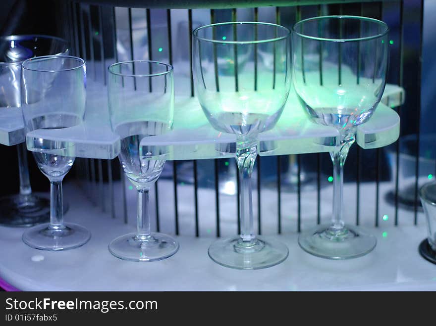 Illuminated bar counter with empty blue glass. Illuminated bar counter with empty blue glass