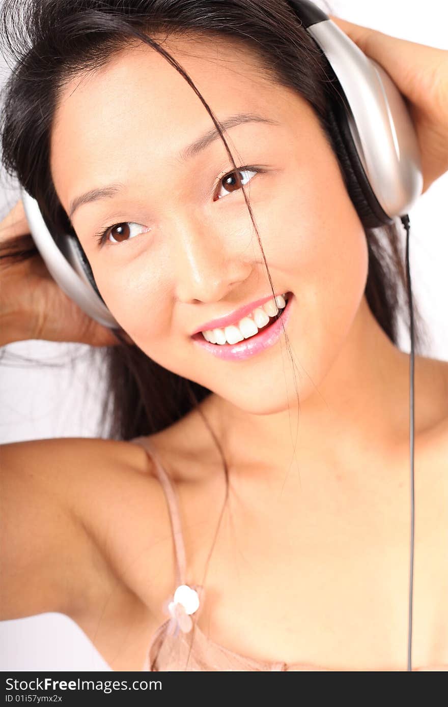 Laughing, happy woman smiling while listening to music; not isolated. Laughing, happy woman smiling while listening to music; not isolated