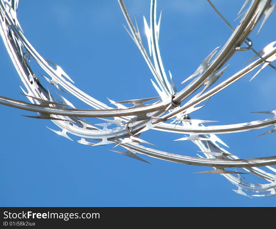 A blue sky and razorwire produced this beautiful site at a prison in Florida. A blue sky and razorwire produced this beautiful site at a prison in Florida.