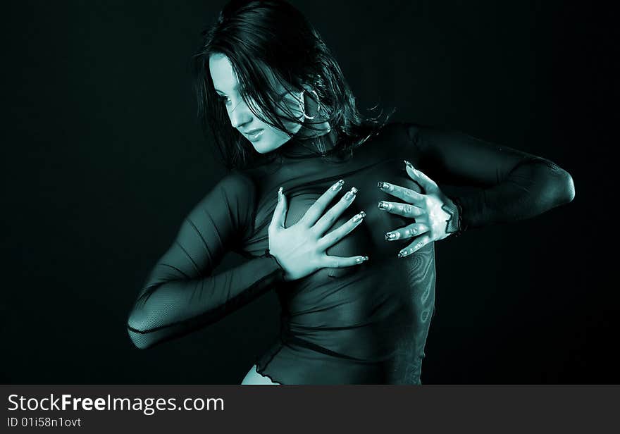 Woman in transparent black clothes on black background. Woman in transparent black clothes on black background