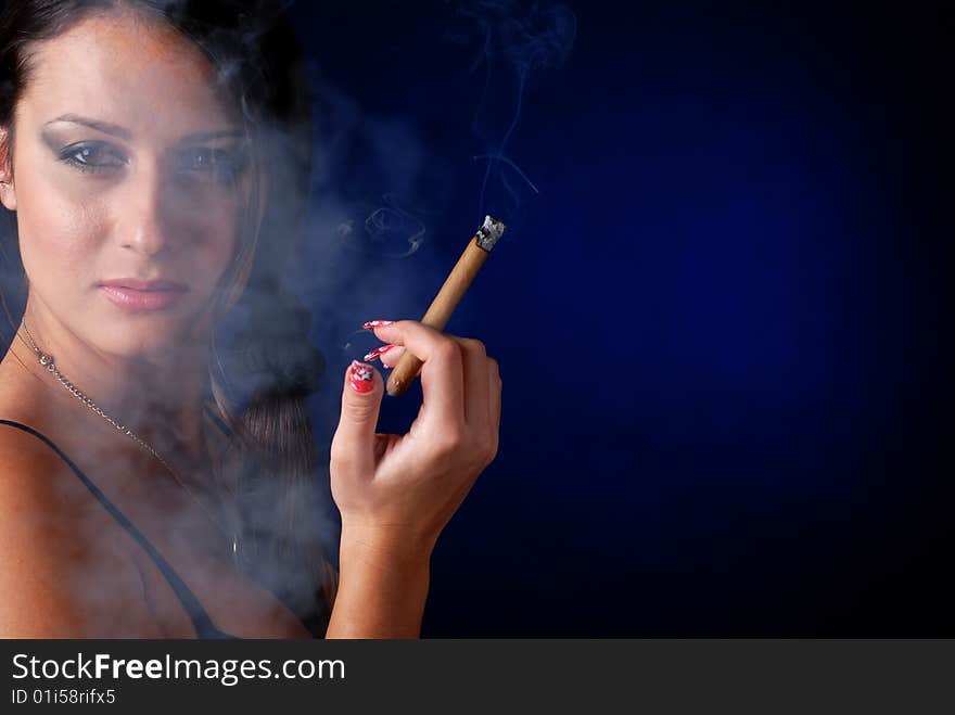 Portrait of beautiful brunet woman with cigar