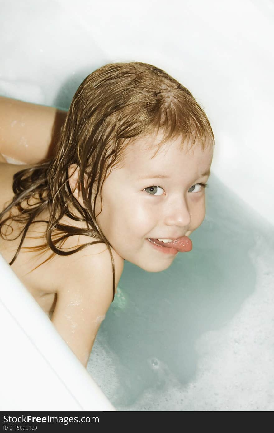 Small girl bathes in the bath