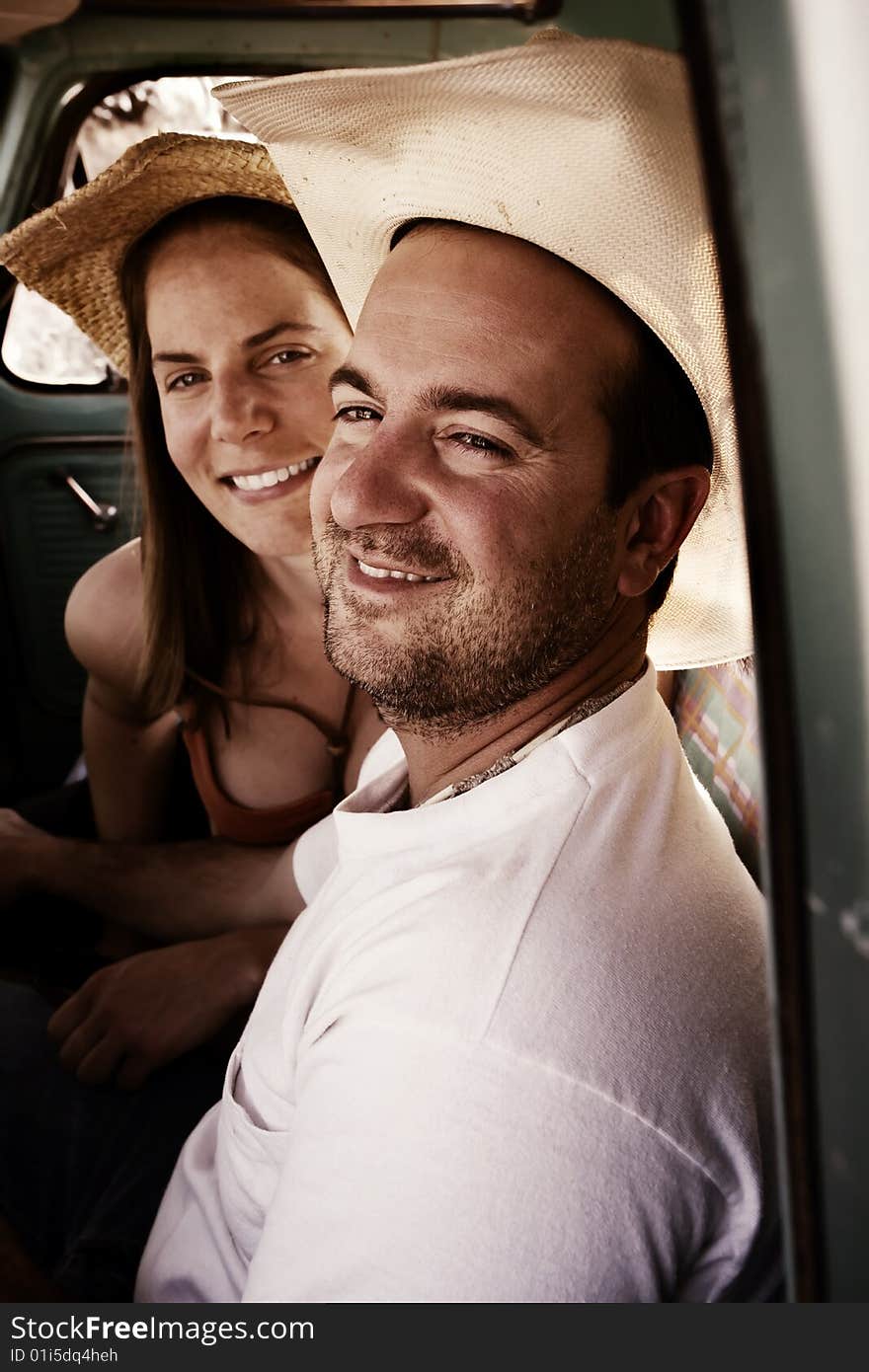 Cowboy and woman in pickup truck