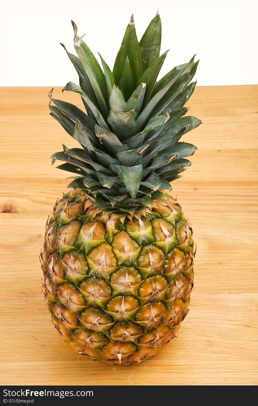 Whole pineapple fruit on a wood table and white background,check also