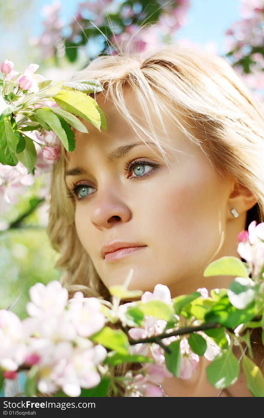 Beautiful girl in a flowering garden