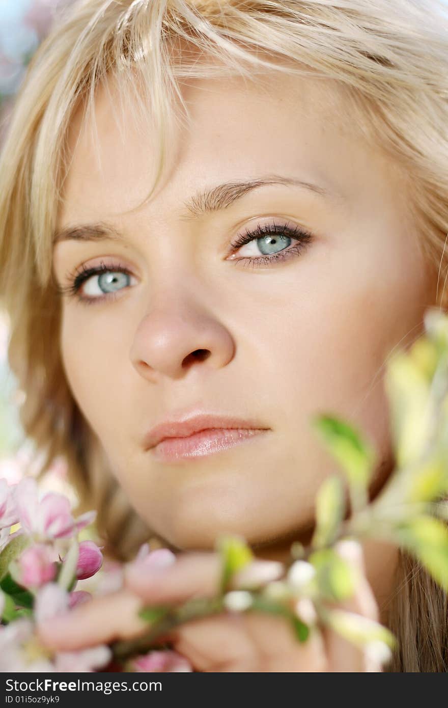 Picture of a beautiful girl in a flowering garden