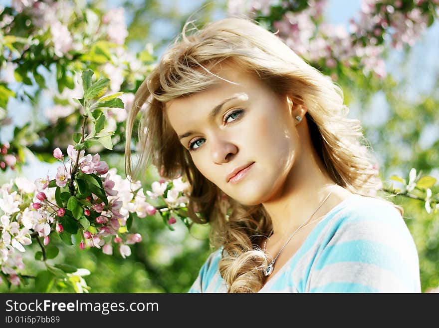 Beautiful girl in a flowering garden