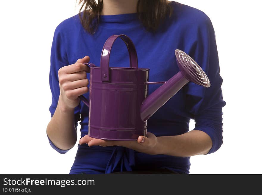 Girl keeps in hands purple watering can. Girl keeps in hands purple watering can