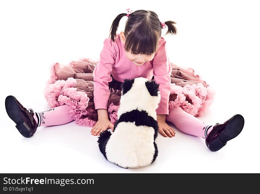 Little girl plays her panda toy. Little girl plays her panda toy