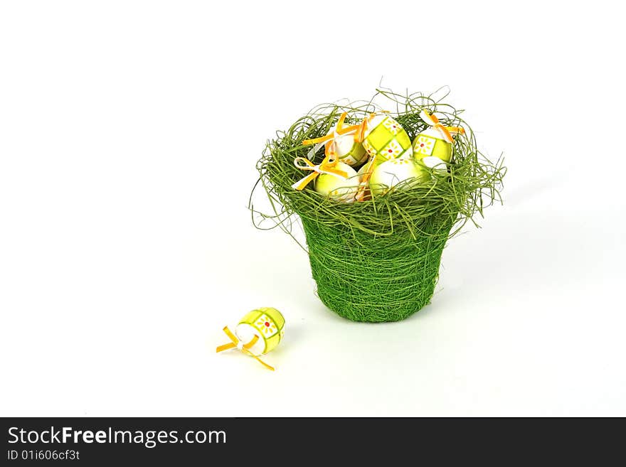 Easter eggs in basket isolated on white