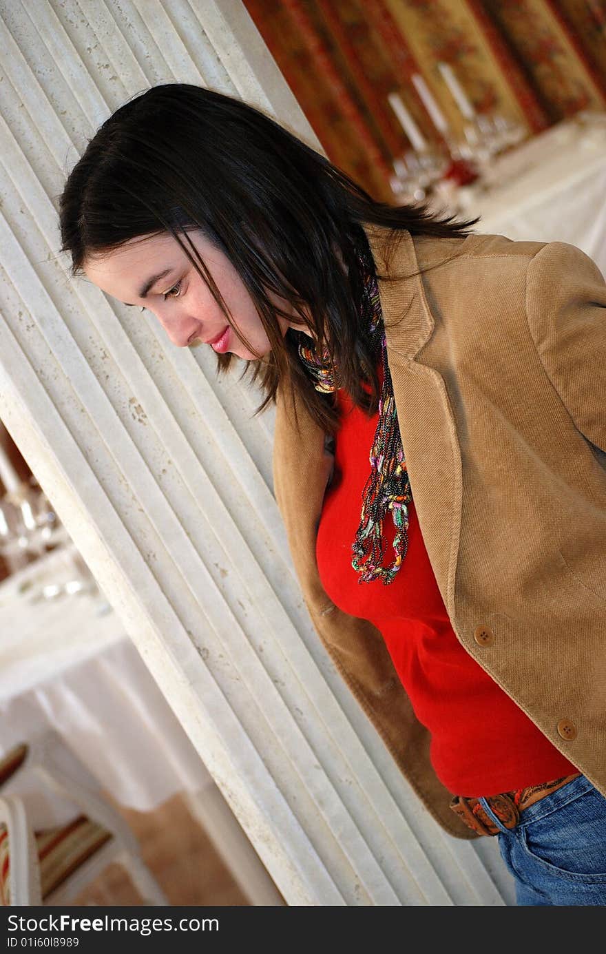 Beautiful young woman thinking in a restaurant