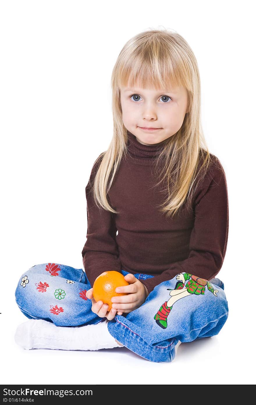 Little blonde girl with orange in hands on white background