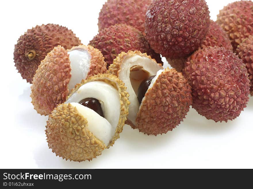 Closeup of fresh litchis over white background