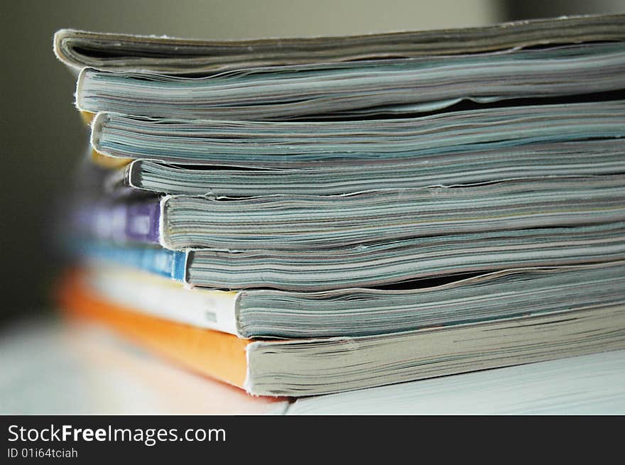 A pile of magazines on white background