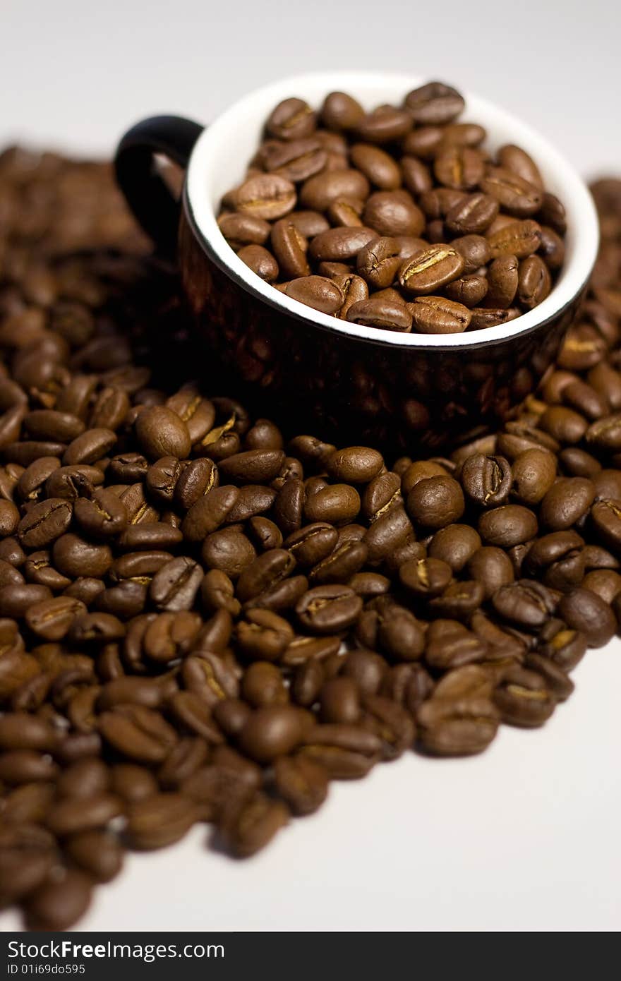 Coffee beans in the cup. Isolated on white background