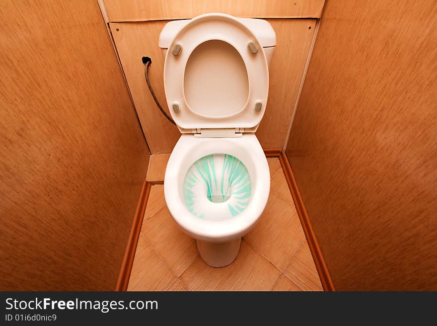 White lavatory pan with green cleaner in it. White lavatory pan with green cleaner in it